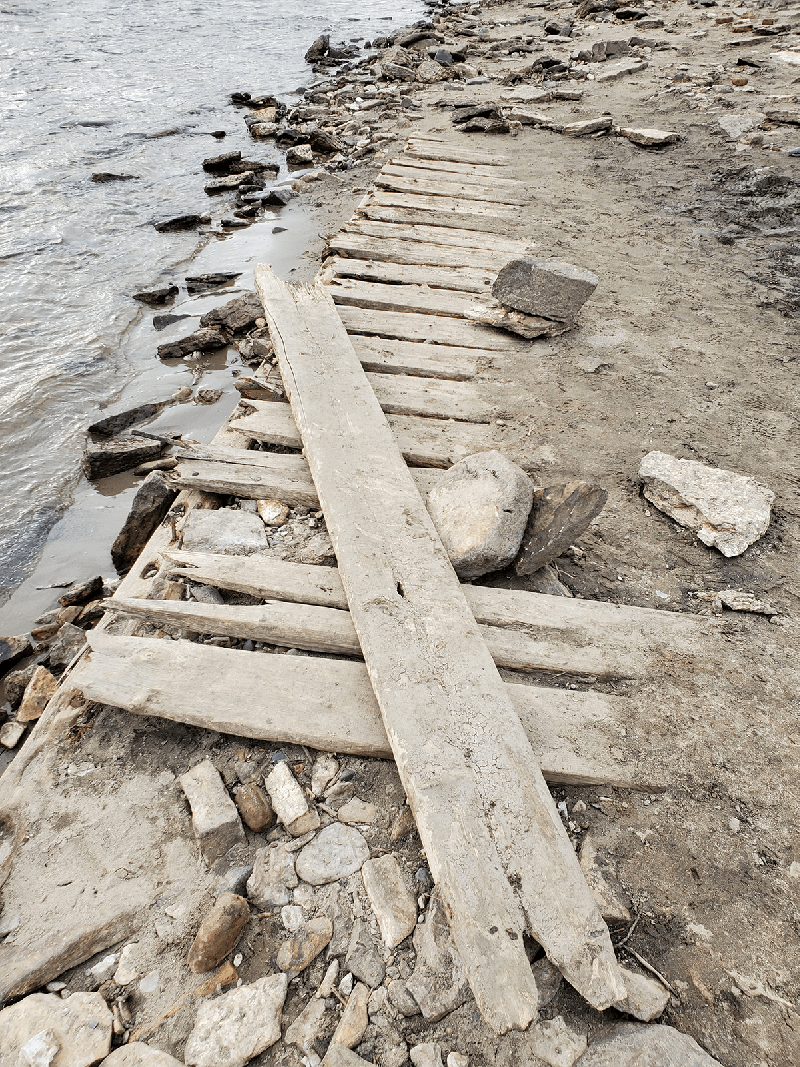 Exposed old planks and rocks