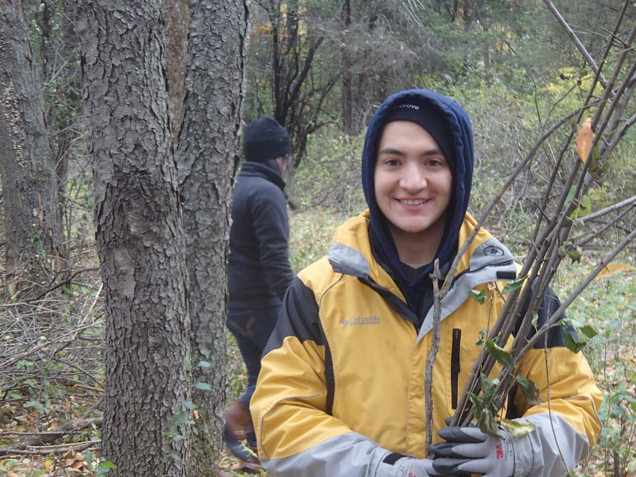 Ravine Park brush haul A volunteer poses with buckthorn sticks at a past Ravine Park brush haul