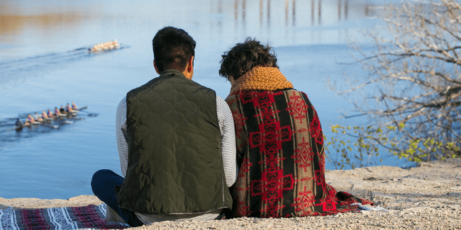 Two people sitting on riverbluff
